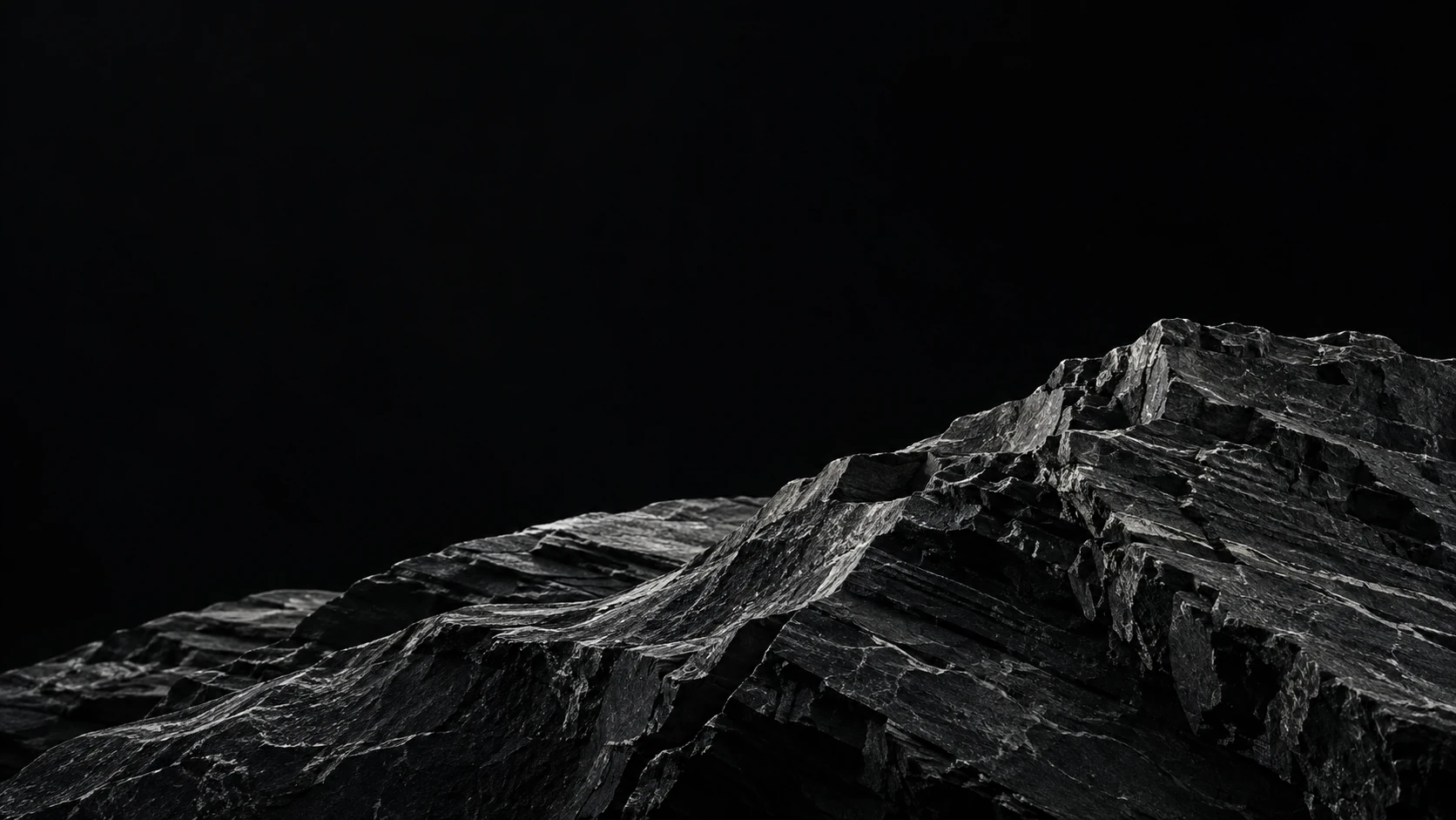 Monochrome close-up of layered natural stone.